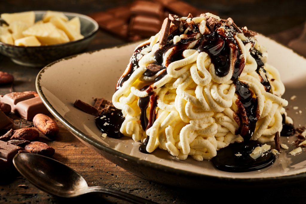 Spaghetti ice cream dessert with sweet chocolate topping
